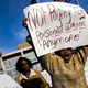 In a protest outside City Hall in Flint, Mich. on Jan. 25, 2016, resident Angela Hickmon, 56, calls for an end to paying water bills in the city until the “man-made disaster” is figured out. Residents tore up and burned their water bills. (Jake May/MLive.com)